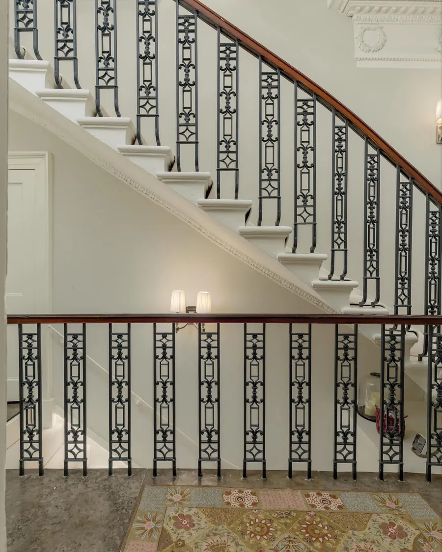 A restored period staircase with ornate ironwork in a listed Edinburgh building